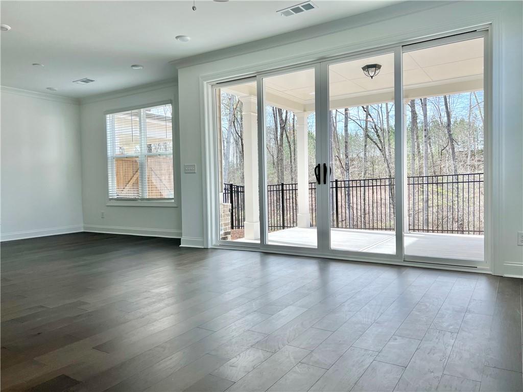 3347 Goodwin Park Suwanee, GA 30024 - Photo 10 of 28 a view of an empty room with wooden floor and a window