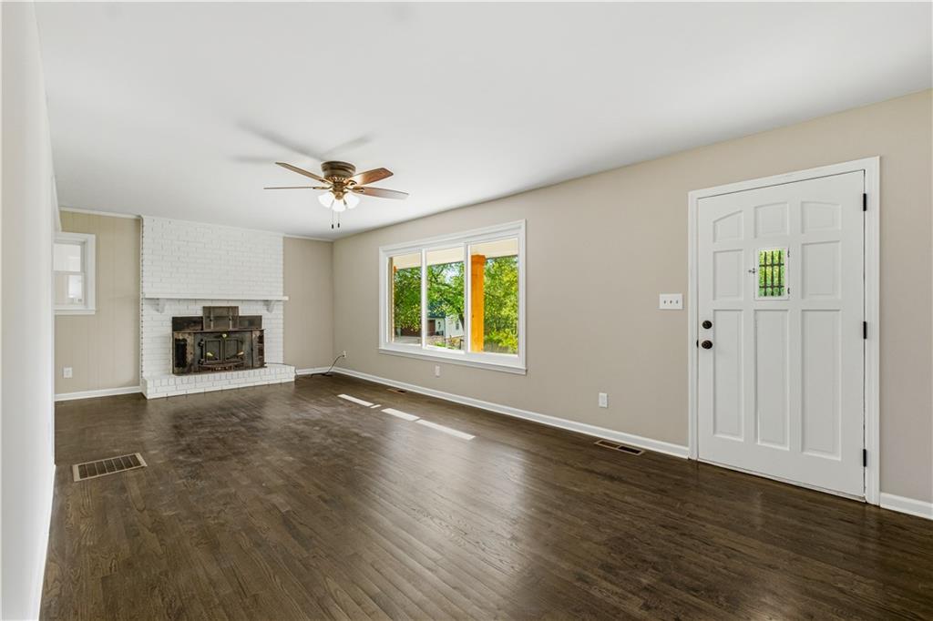 5605 Burke Lane Gainesville, GA 30506 - Photo 17 of 62 an empty room with wooden floor ceiling fan and windows
