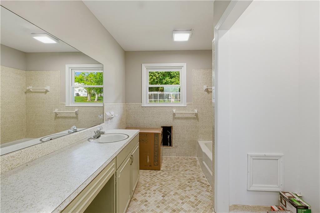 5605 Burke Lane Gainesville, GA 30506 - Photo 34 of 62 a spacious bathroom with a double vanity sink a mirror and a bathtub