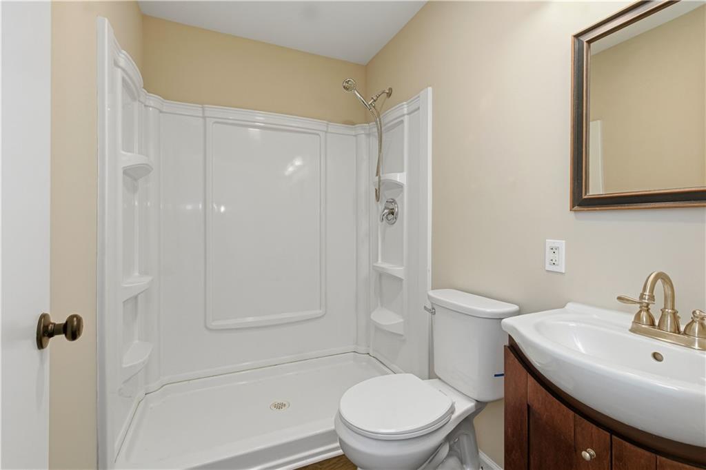 5605 Burke Lane Gainesville, GA 30506 - Photo 40 of 62 a bathroom with a toilet a sink a mirror and vanity