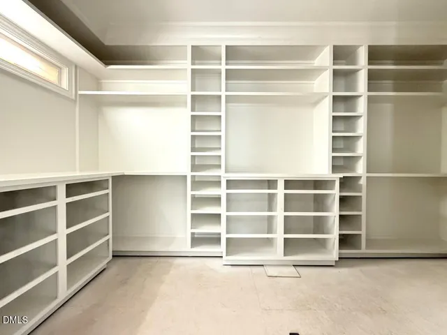 a view of an empty room with empty shelves