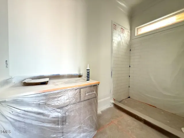 a bathroom with a tub sink and shower