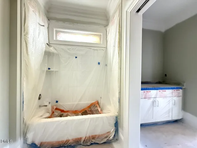 a bath room with a bathtub and closet
