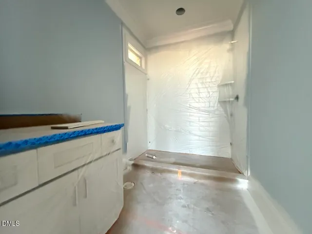 a view of water heater room with wooden floor