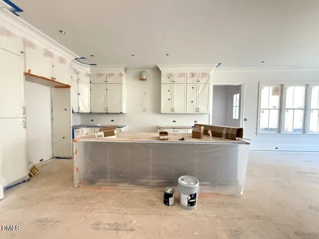 a living room with stainless steel appliances kitchen island granite countertop furniture and a refrigerator