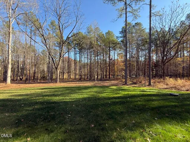 a swimming pool with outdoor seating and yard