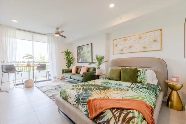 a bedroom with a bed and glass walk in closet