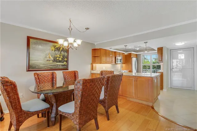 a living room with furniture a ceiling fan and a large window