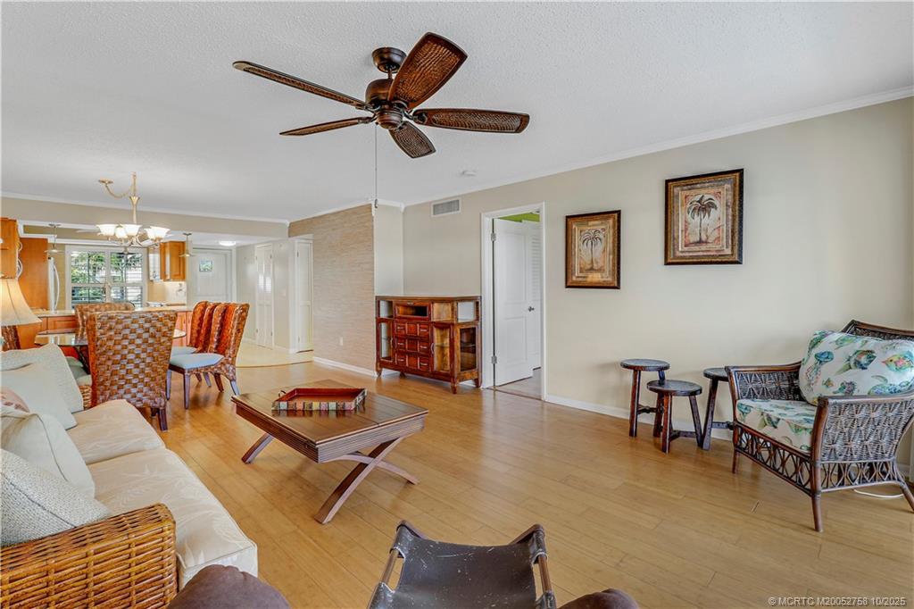 1866 Southwest Palm City Road, Unit 204 Stuart, FL 34994 - Photo 17 of 56 a living room with furniture and a wooden floor