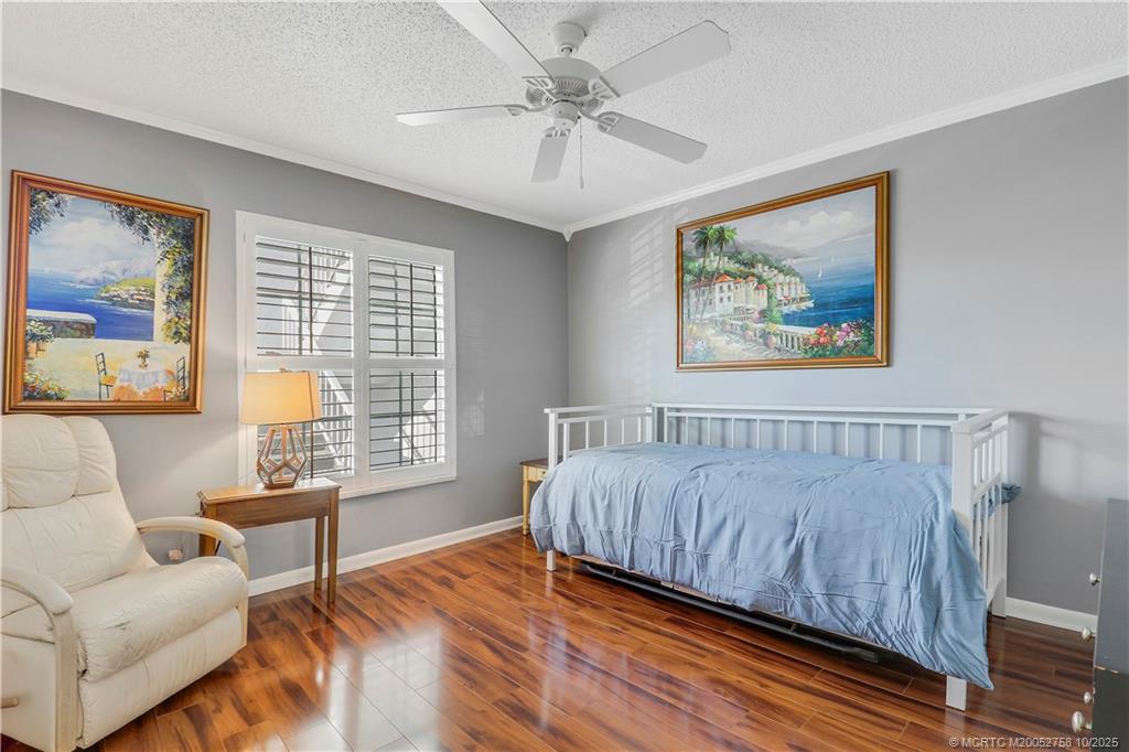 1866 Southwest Palm City Road, Unit 204 Stuart, FL 34994 - Photo 22 of 56 a bedroom with a bed and a couch