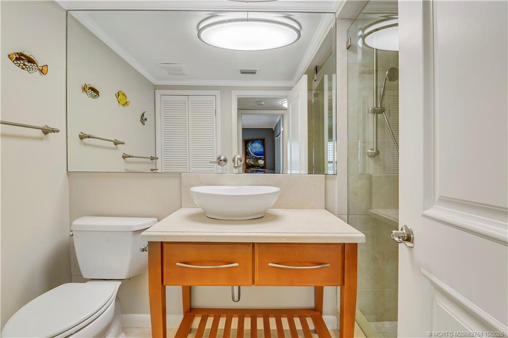 1866 Southwest Palm City Road, Unit 204 Stuart, FL 34994 - Photo 24 of 56 a bathroom with a toilet sink and mirror