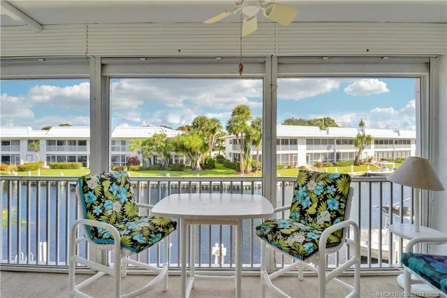 a view of a balcony furniture and floor to ceiling window