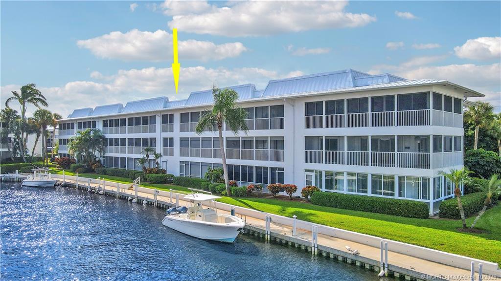 1866 Southwest Palm City Road, Unit 204 Stuart, FL 34994 - Photo 34 of 56 a front view of a house with a yard and potted plants