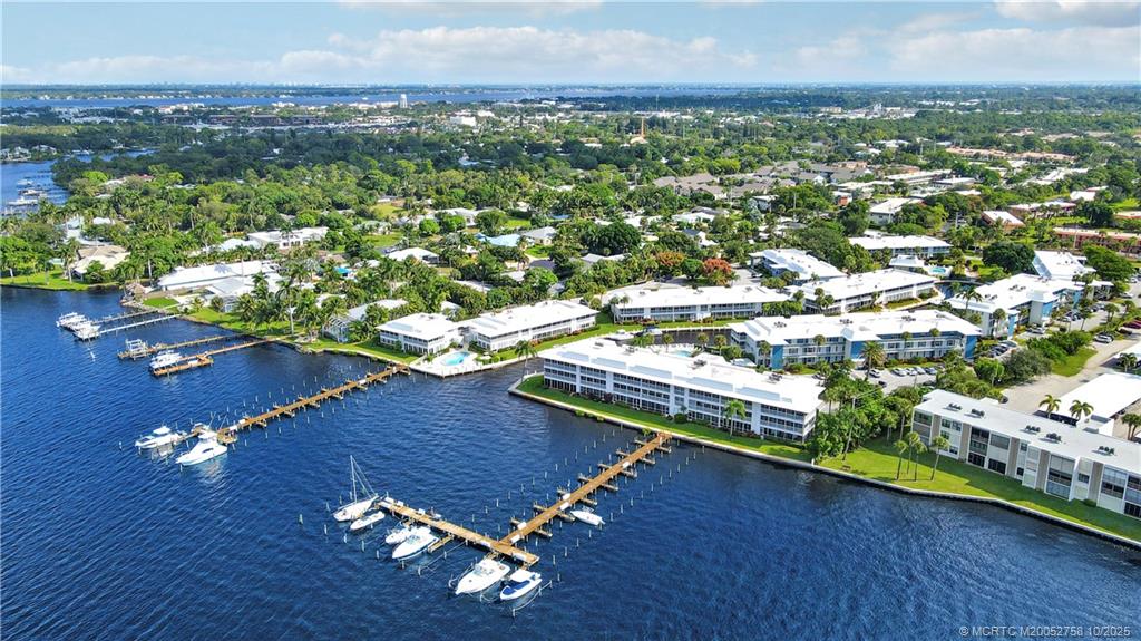 1866 Southwest Palm City Road, Unit 204 Stuart, FL 34994 - Photo 42 of 56 an aerial view of residential houses with outdoor space and trees