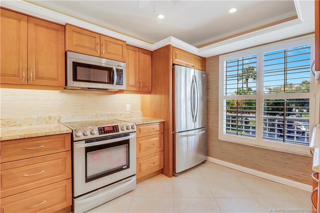 1866 Southwest Palm City Road, Unit 204 Stuart, FL 34994 - Photo 8 of 56 a kitchen with stainless steel appliances granite countertop cabinets and a stove top oven