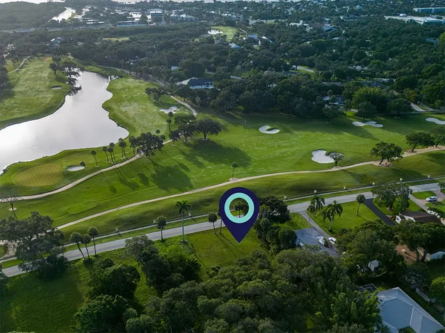 an aerial view of a golf course with parking space