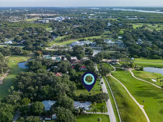 an aerial view of a golf course with parking space