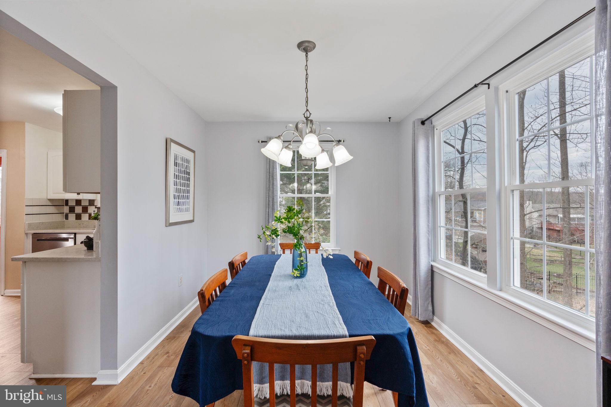 502 Durango Road Catonsville, MD 21228 - Photo 12 of 74 a dining room with furniture a chandelier and wooden floor