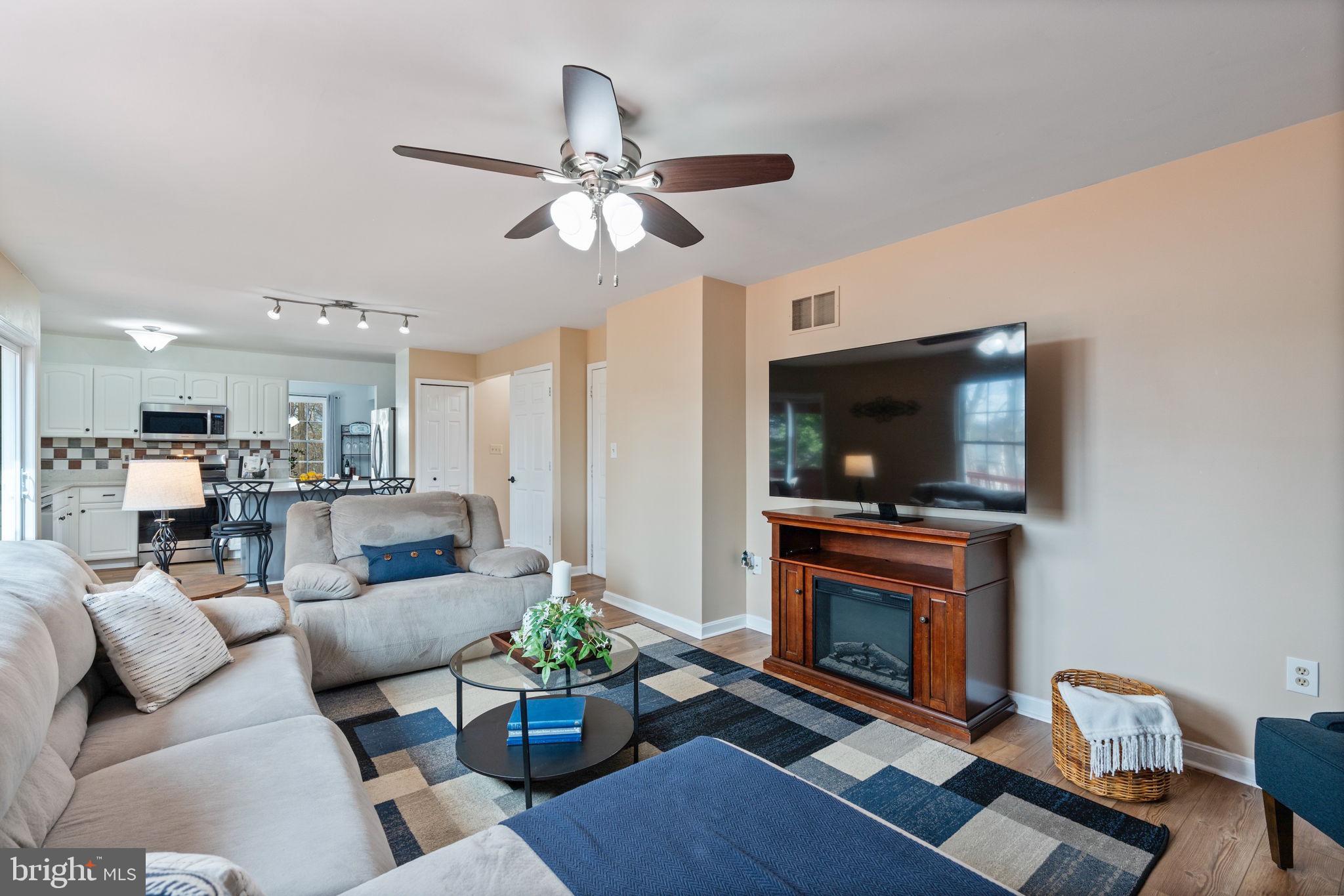 502 Durango Road Catonsville, MD 21228 - Photo 22 of 74 a living room with furniture a flat screen tv and kitchen view