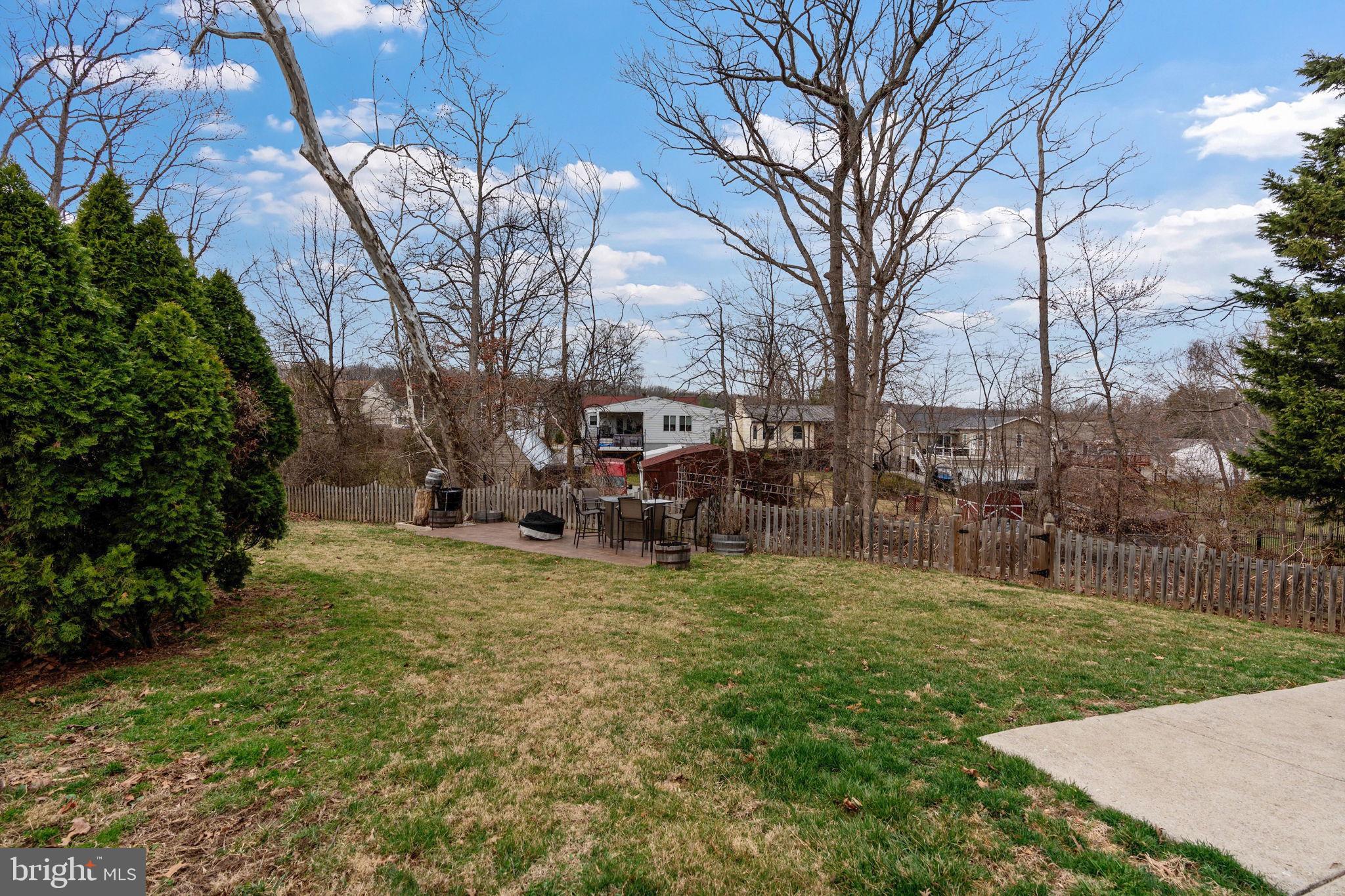 502 Durango Road Catonsville, MD 21228 - Photo 39 of 74 a view of a backyard with table and chairs and a large tree