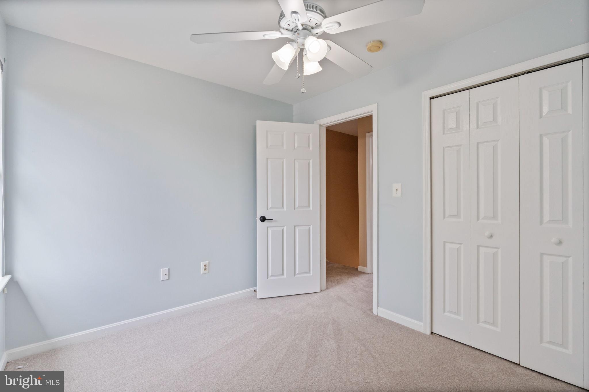 502 Durango Road Catonsville, MD 21228 - Photo 44 of 74 an empty room with a ceiling fan and a window