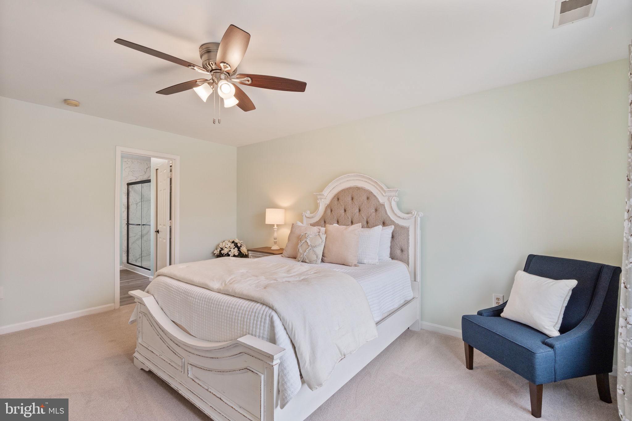 502 Durango Road Catonsville, MD 21228 - Photo 51 of 74 a bedroom with a bed and a chandelier