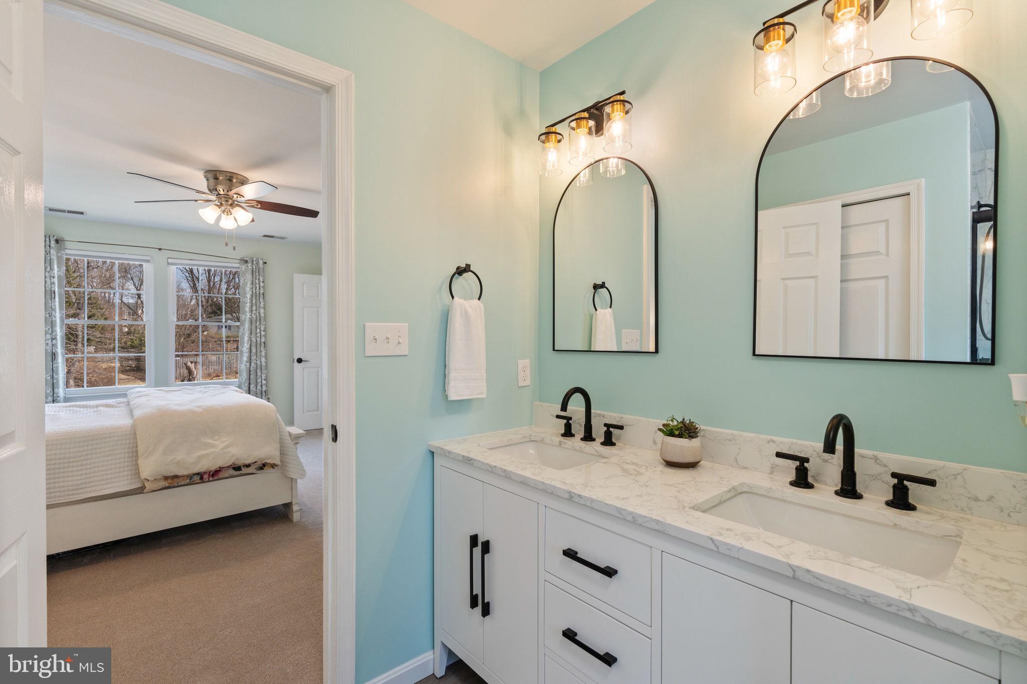 502 Durango Road Catonsville, MD 21228 - Photo 58 of 74 a en suite bathroom with a double vanity sink and a mirror