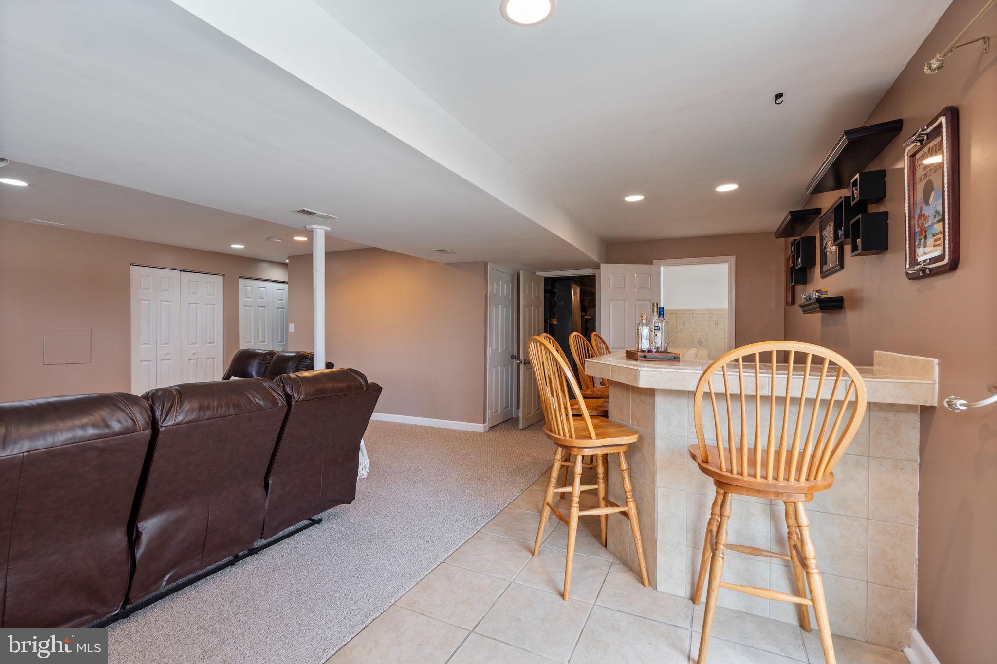 502 Durango Road Catonsville, MD 21228 - Photo 61 of 74 a living room with furniture a dining table and a bookshelf with wooden floor
