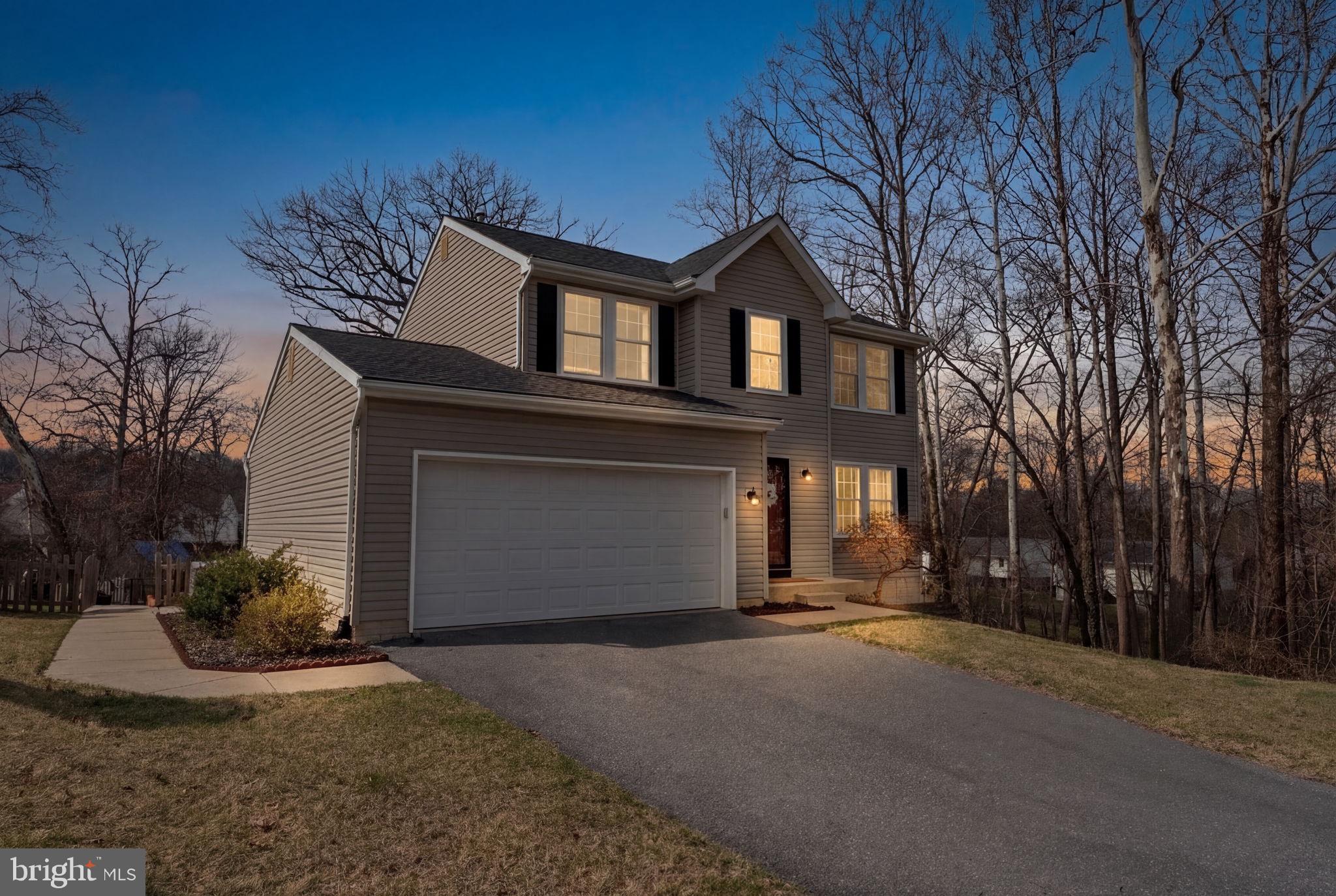 502 Durango Road Catonsville, MD 21228 - Photo 69 of 74 a front view of a house with a yard and garage