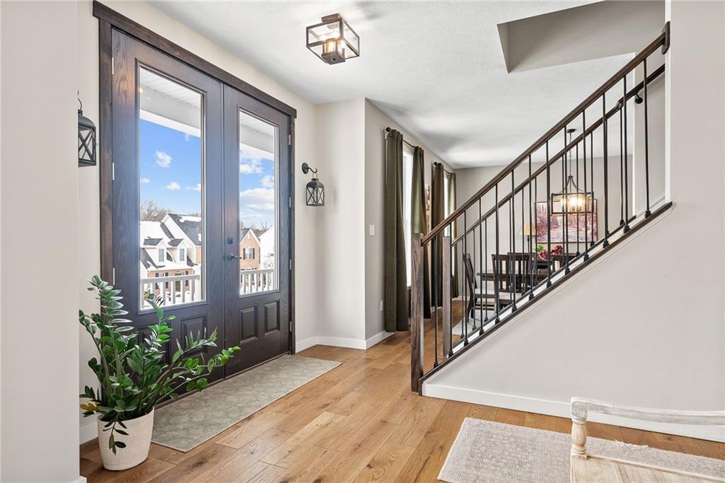 141 Morningstar Drive Rostraver Township, PA 15012 - Photo 2 of 39 A refined entry framed by glass and wood detailing, introducing clean lines and a bright, welcoming interior.