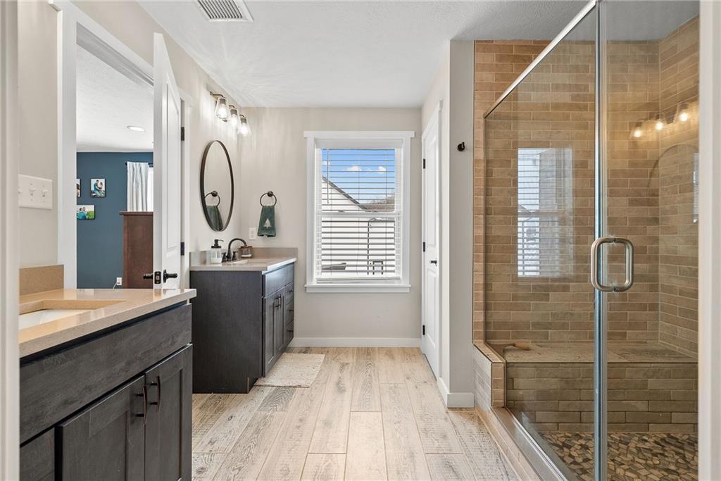 141 Morningstar Drive Rostraver Township, PA 15012 - Photo 23 of 39 An oversized glass-enclosed shower creates a clean, spa-inspired focal point within the primary bath.