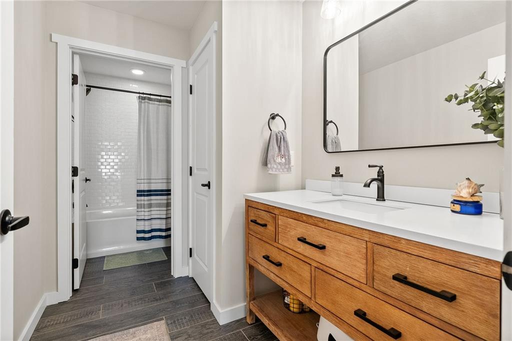 141 Morningstar Drive Rostraver Township, PA 15012 - Photo 28 of 39 A hallway bath finished with custom tile details and a clean, modern aesthetic.