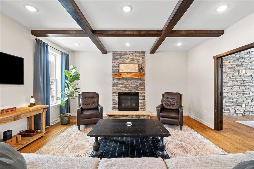141 Morningstar Drive Rostraver Township, PA 15012 - Photo 5 of 39 A welcoming family room centered around a stone fireplace that adds warmth, texture, and a natural focal point.