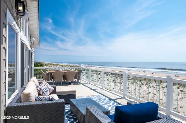 a living room with furniture a rug and a floor to ceiling window