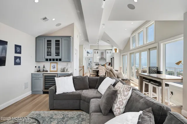a living room with furniture kitchen view and a large window