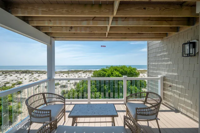 a view of a chairs and table in the balcony