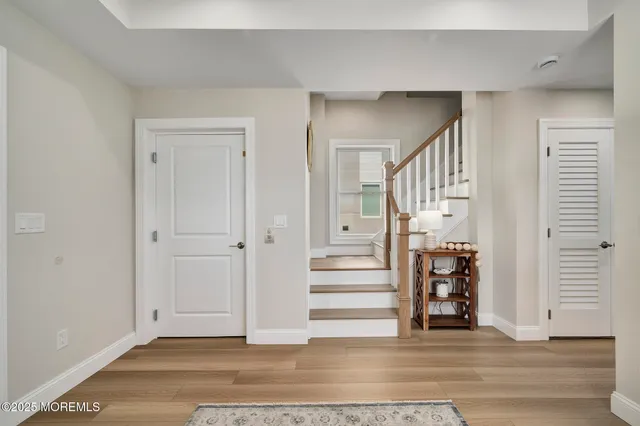 a view of entryway and hall with wooden floor