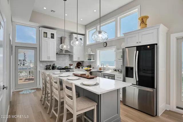 a kitchen with stainless steel appliances kitchen island a refrigerator and a stove top oven