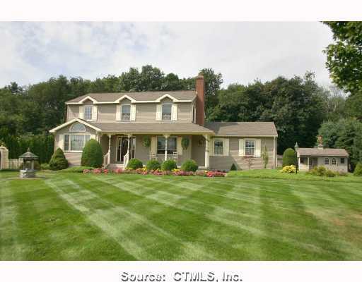 5 Olde Farm Road Ellington, CT 06029 - Photo 1 of 1 a front view of a house with a garden