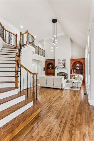 a dining room with furniture a chandelier and wooden floor