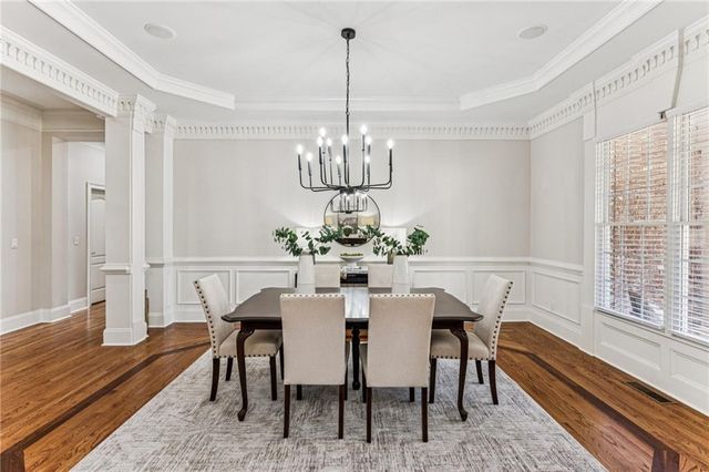 a large kitchen with kitchen island a sink table and chairs