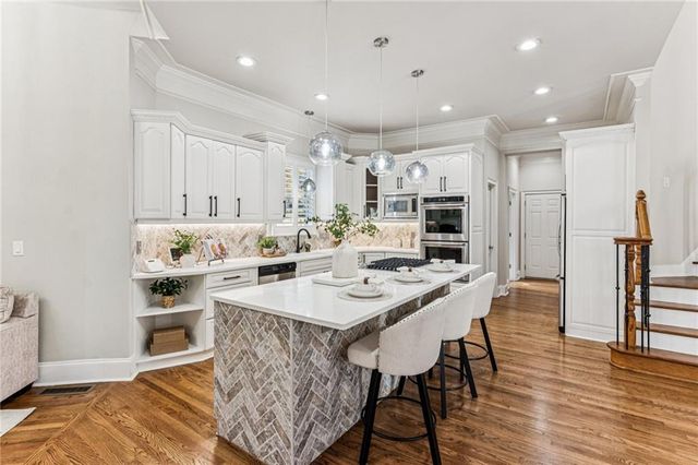 a kitchen with appliances and cabinets