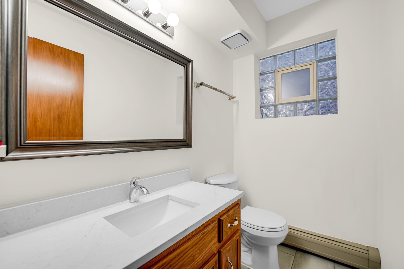 5324 Long Avenue, Unit 1 Chicago, IL 60638 - Photo 14 of 18 a bathroom with a sink mirror vanity and toilet