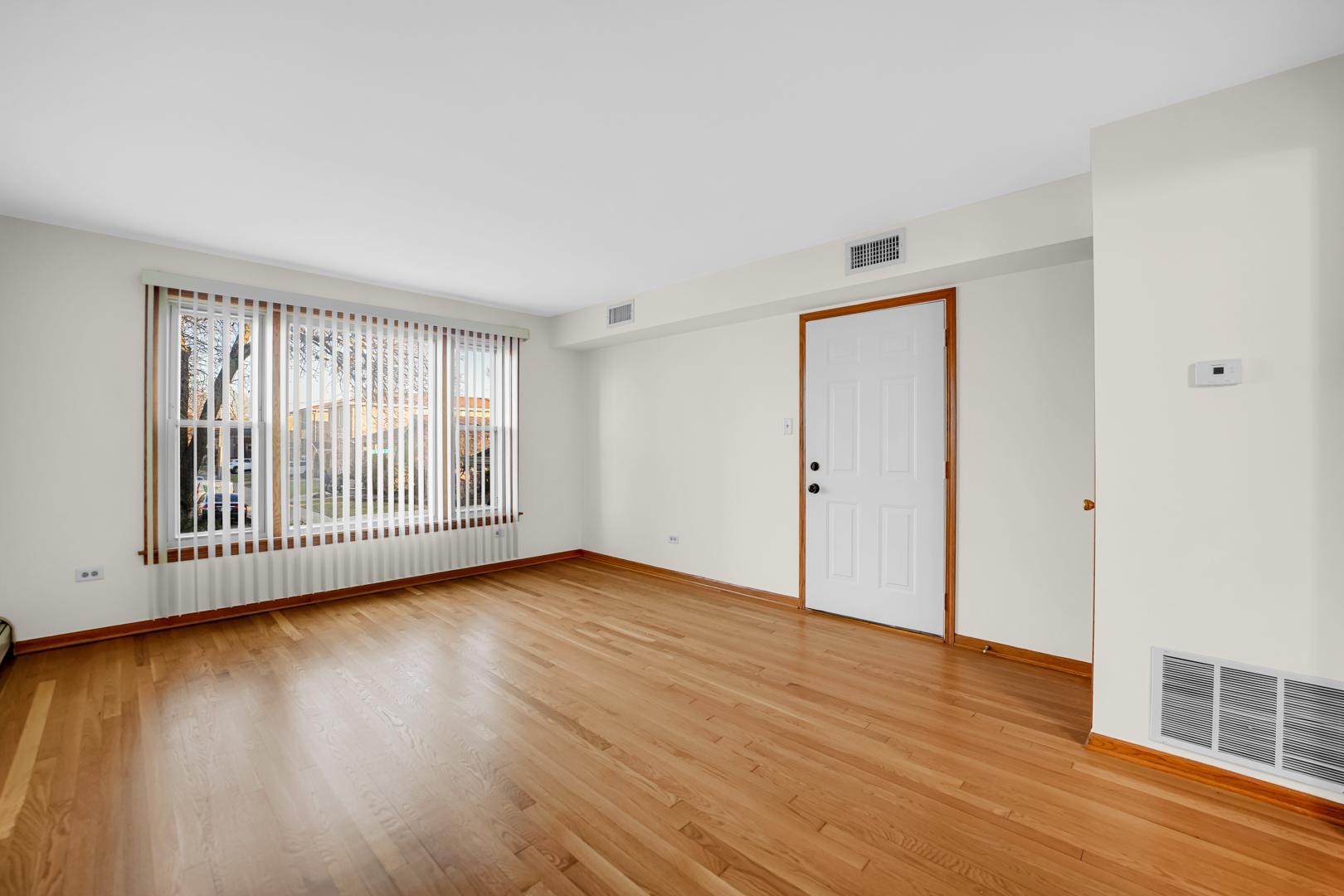 5324 Long Avenue, Unit 1 Chicago, IL 60638 - Photo 2 of 18 a view of an empty room with wooden floor and a window