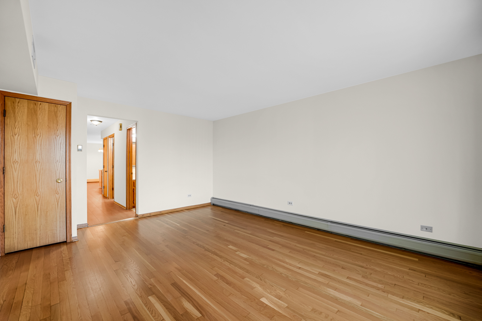 5324 Long Avenue, Unit 1 Chicago, IL 60638 - Photo 3 of 18 a view of an empty room with wooden floor and a window