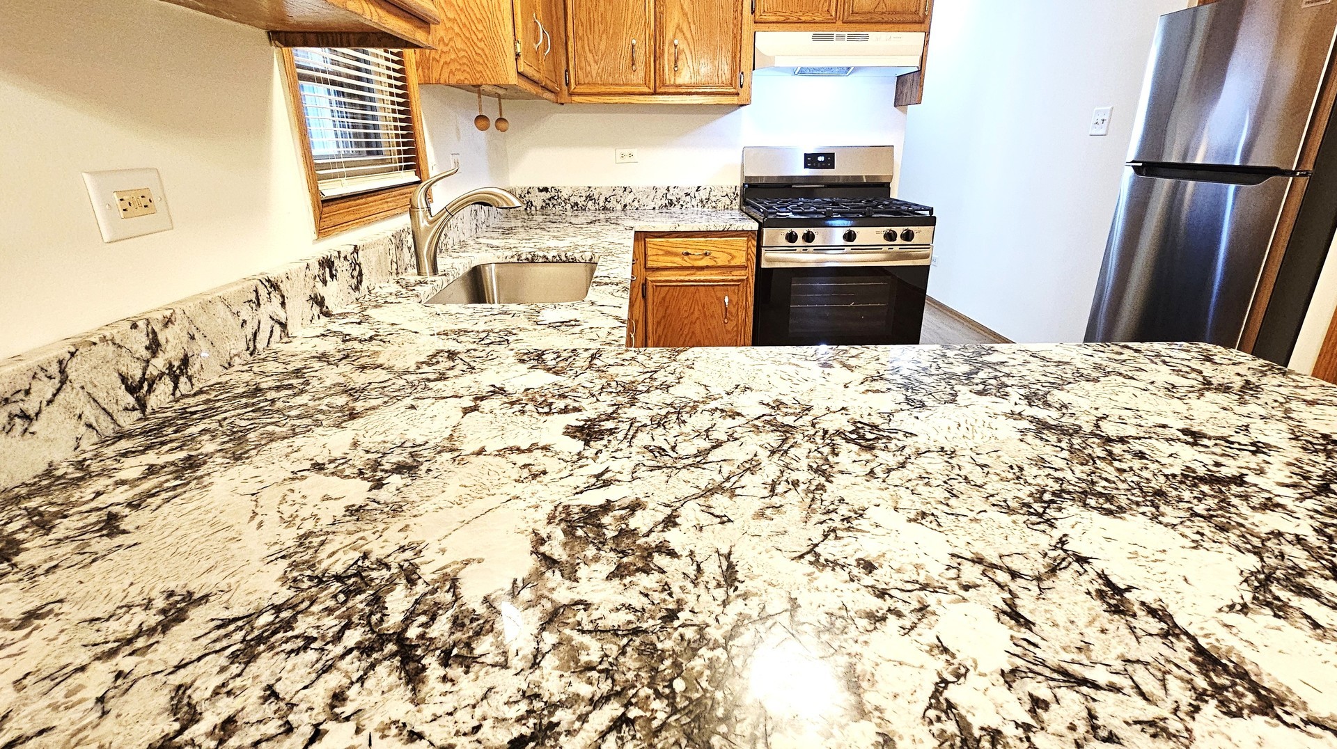 5324 Long Avenue, Unit 1 Chicago, IL 60638 - Photo 7 of 18 a kitchen with granite countertop a refrigerator and a stove