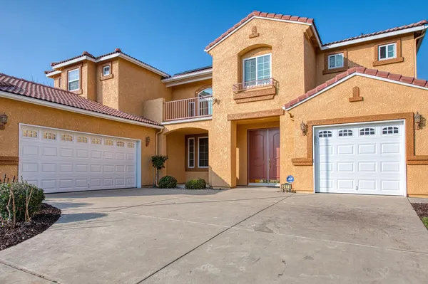 a large kitchen with stainless steel appliances granite countertop a sink and dishwasher a stove top oven with wooden floor