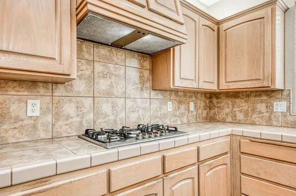 a view of a kitchen with a sink and a fireplace