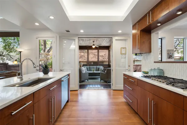 a kitchen with stainless steel appliances a sink stove and cabinets