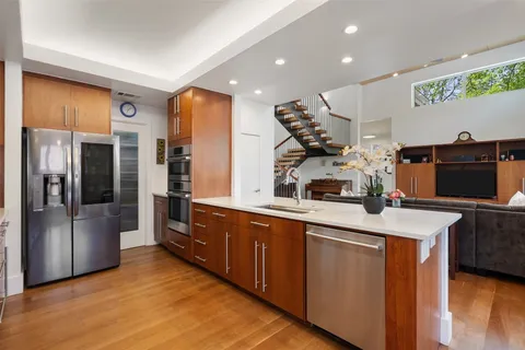 a kitchen with stainless steel appliances granite countertop a stove and a refrigerator